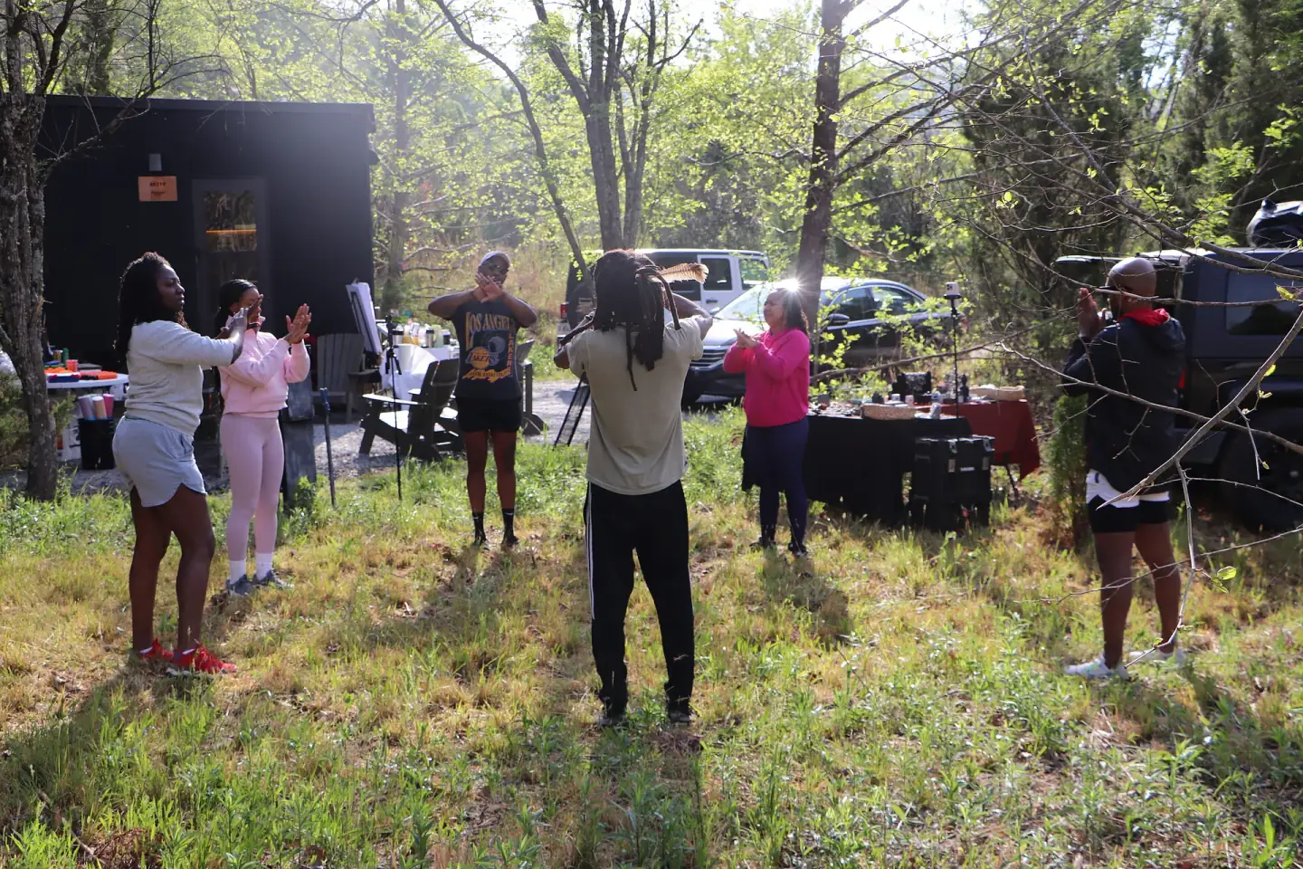 Retreat participants moving together outdoors at golden hour